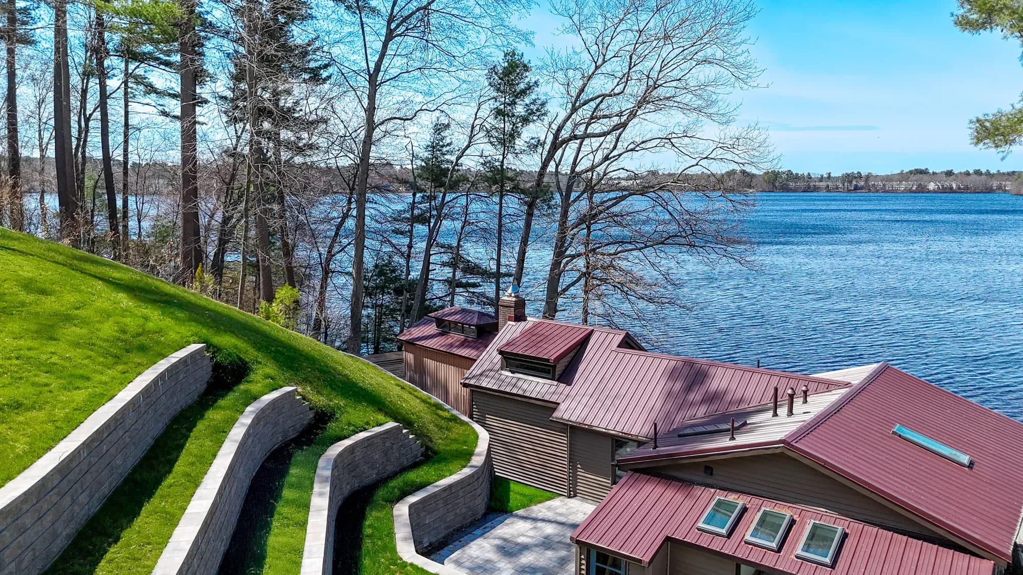 Terraced retaining walls following the hillside beside the home and waterfront.