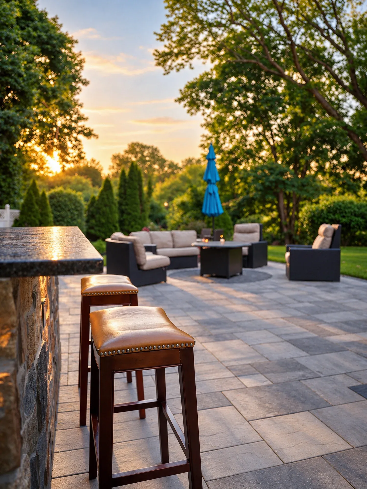 Stone-faced patio bar and lounge seating beside the Westwood paver terrace.