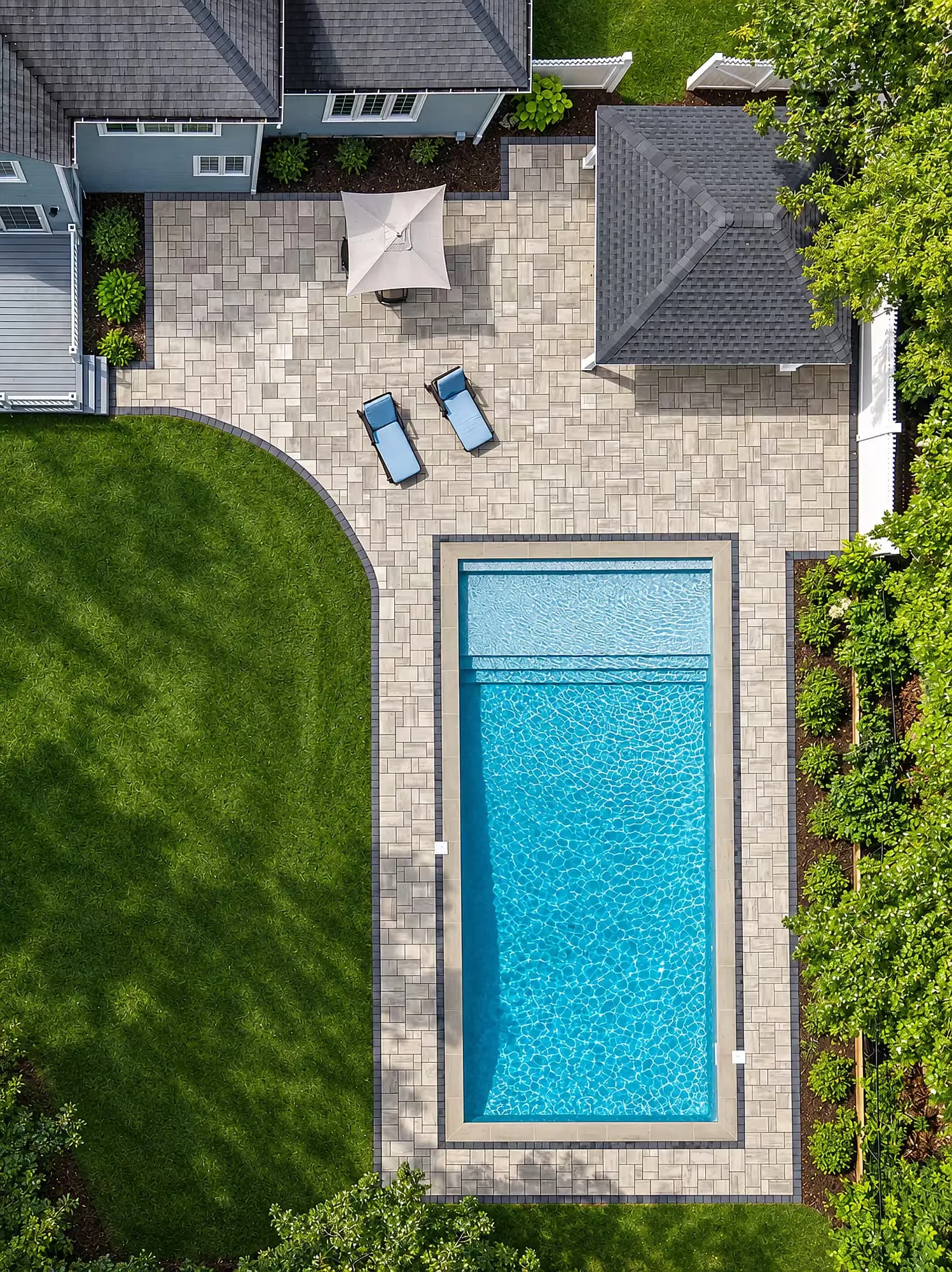 Overhead layout of the patio, pavilion, and pool deck curving along the lawn in Mansfield, MA.