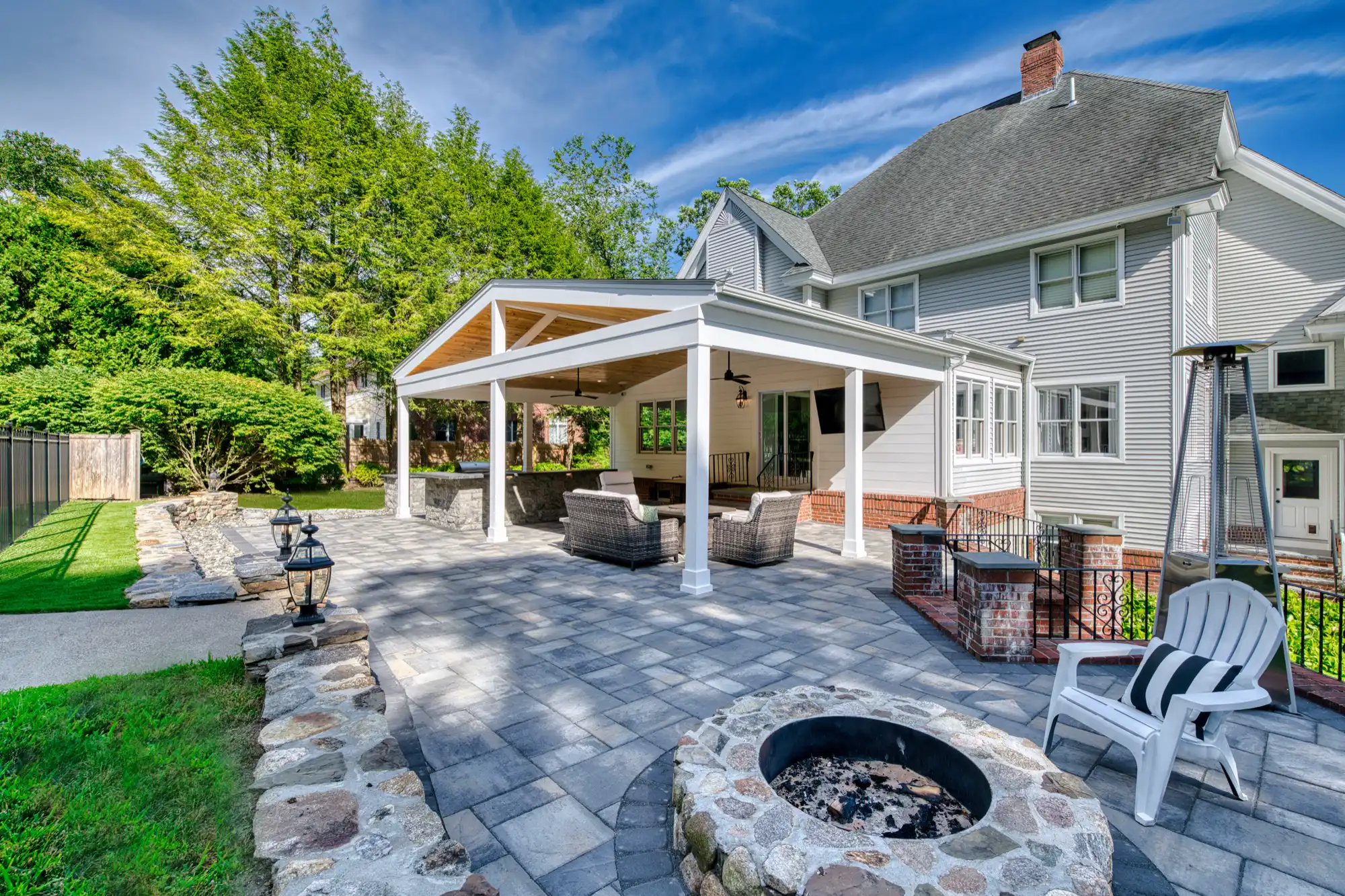 View from the fire-pit area toward the pavilion and adjoining house steps.