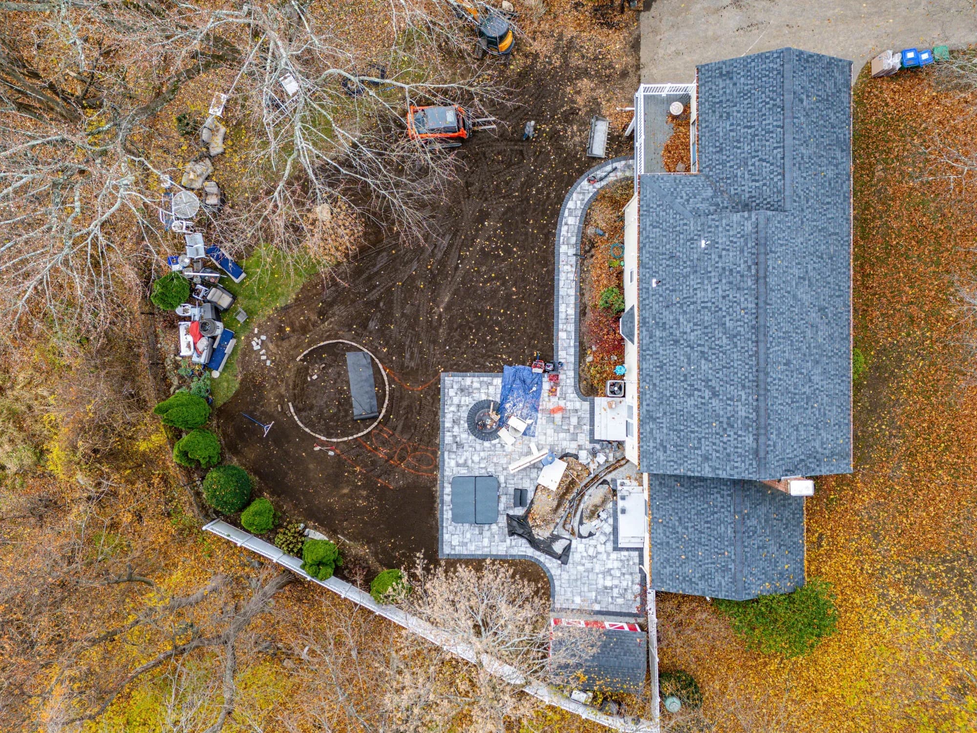 Construction progress: installed paver patio and curved walkway with the circular fire-pit area taking shape.