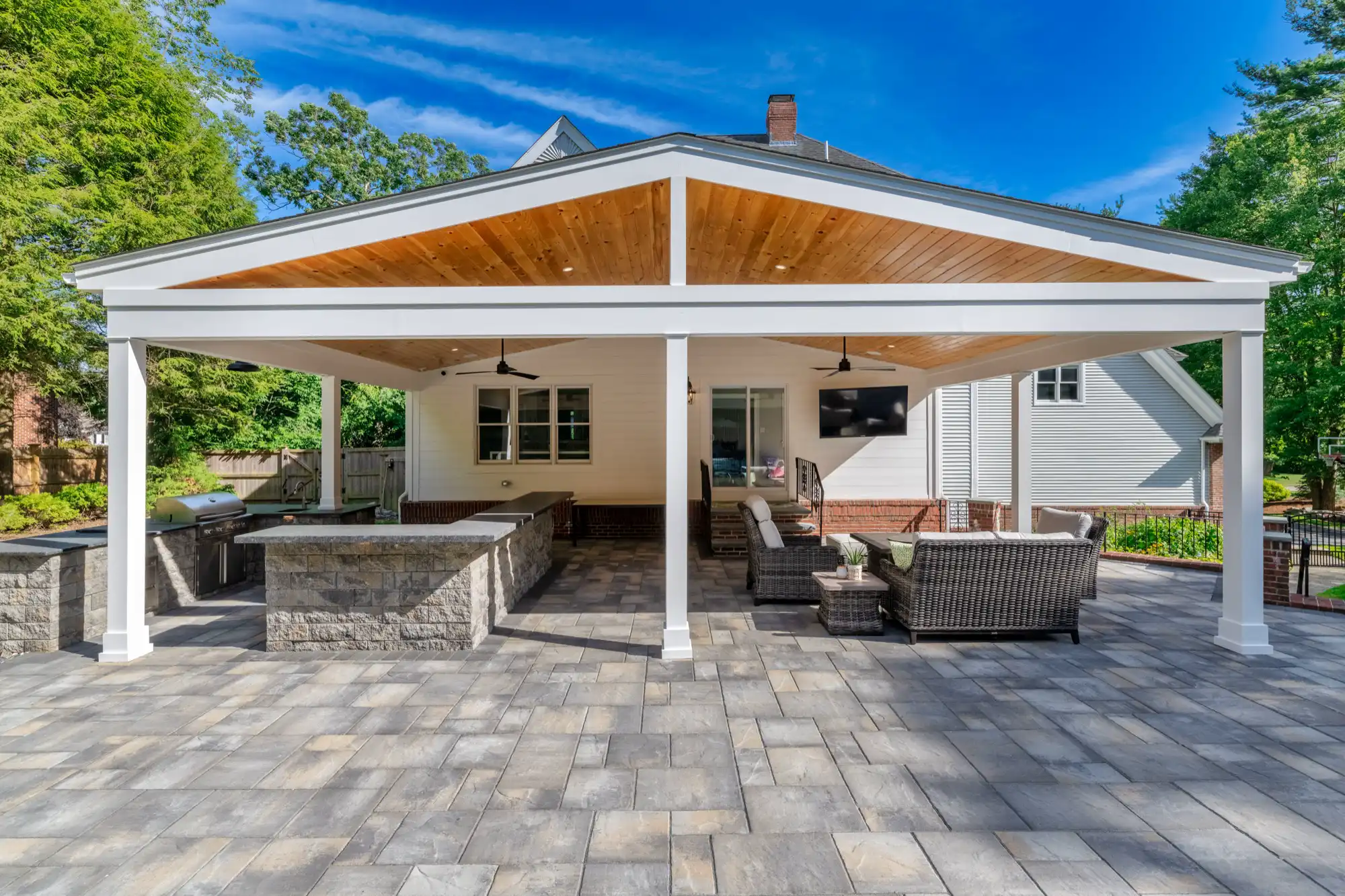 Front view of the pavilion with a kitchen on one side and lounge seating on the other.