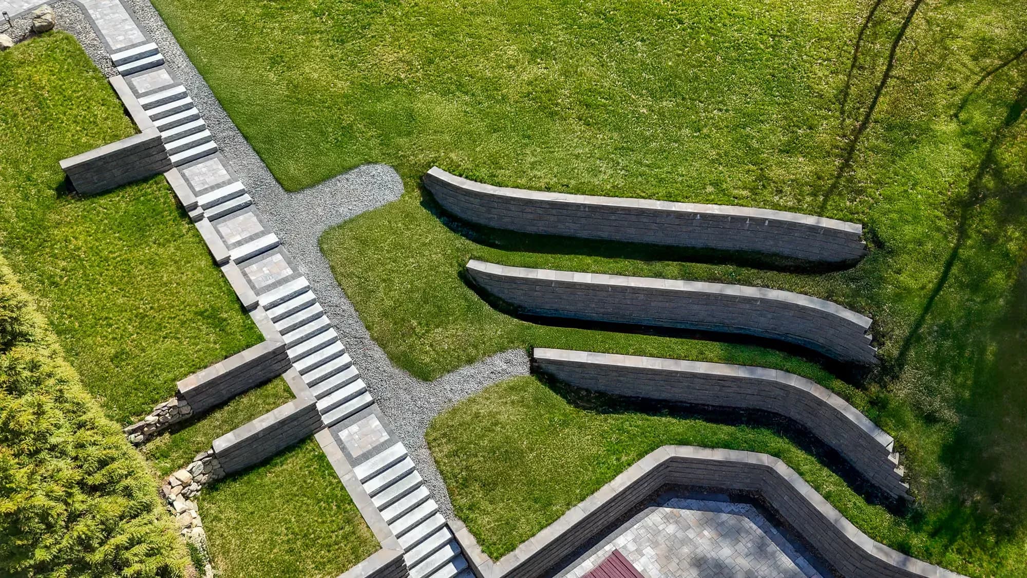 Overhead view of the stairway, paved landings, and curved lawn terraces.