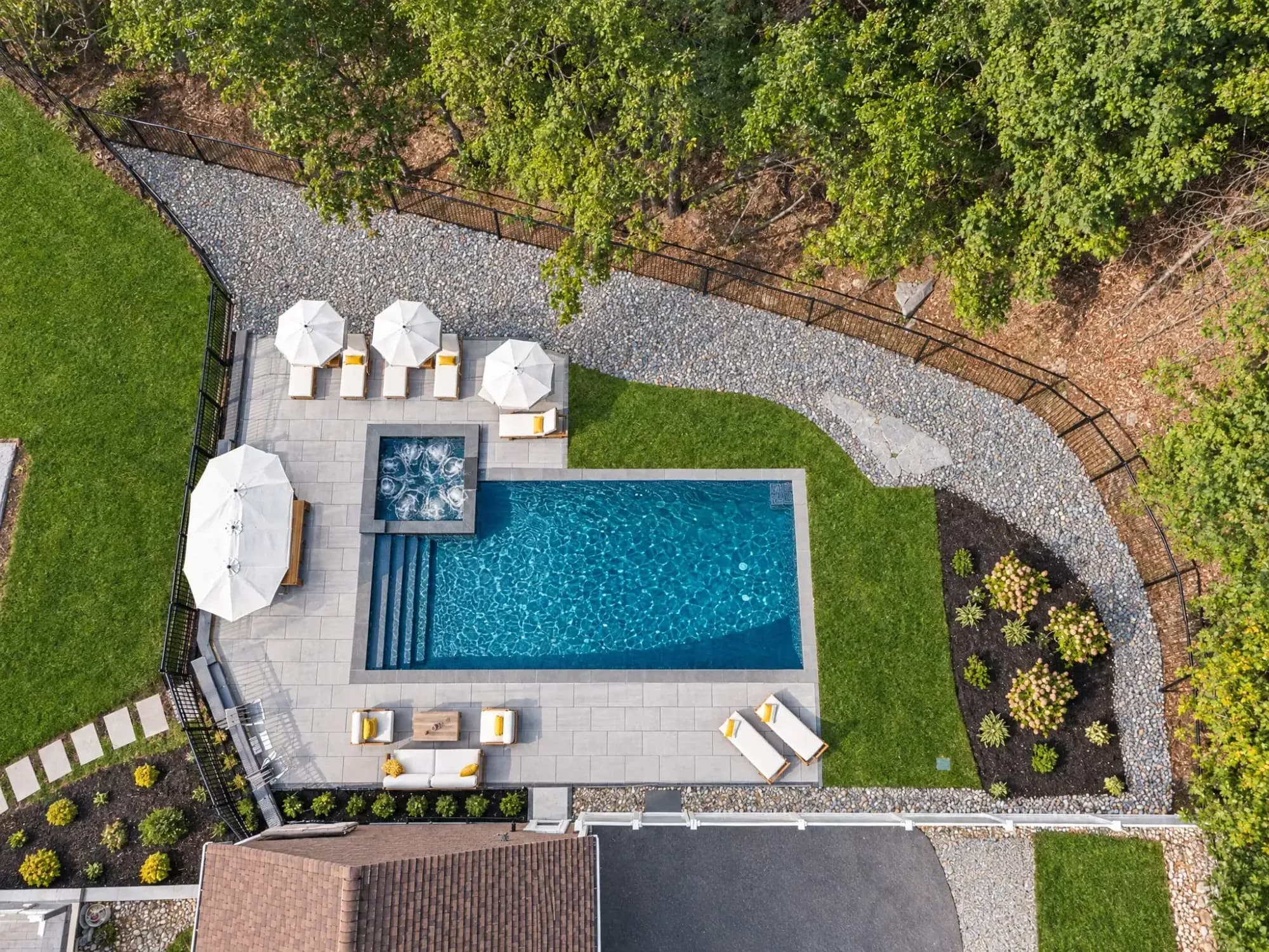 Overhead view of the Easton pool, spa, paver terrace, and surrounding landscape.