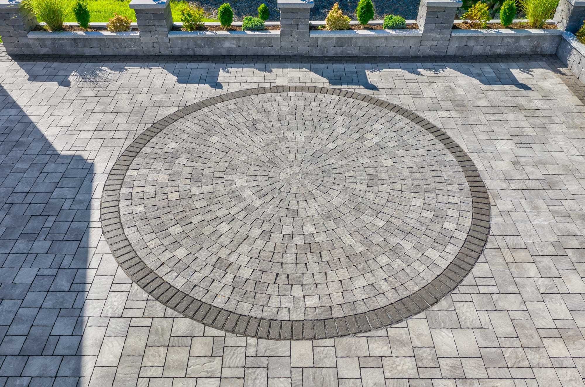 Overhead detail of the radial paver circle and dark border within the driveway.
