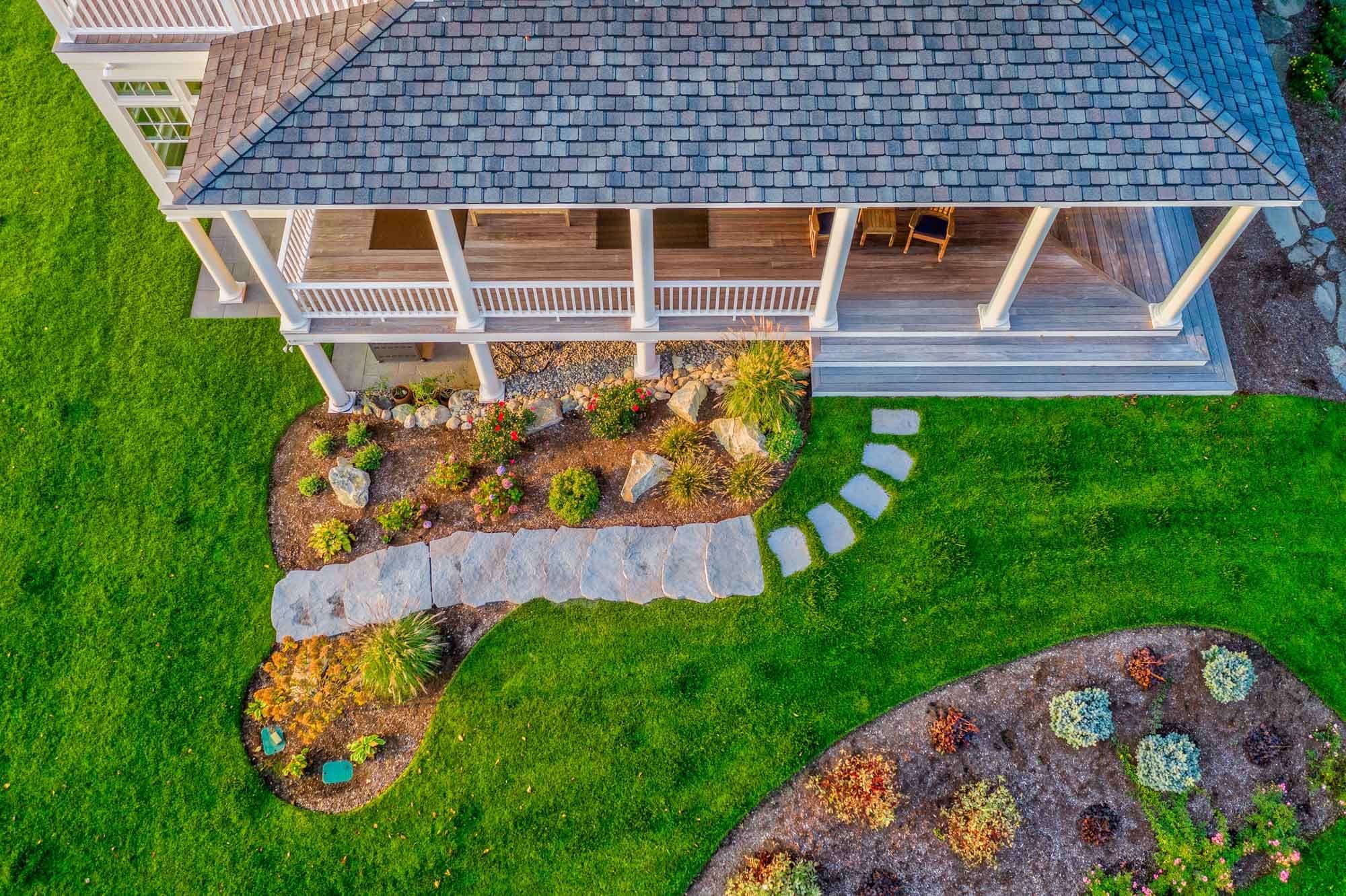 Overhead view of a stone landing and curved stepping-stone path through the lawn.