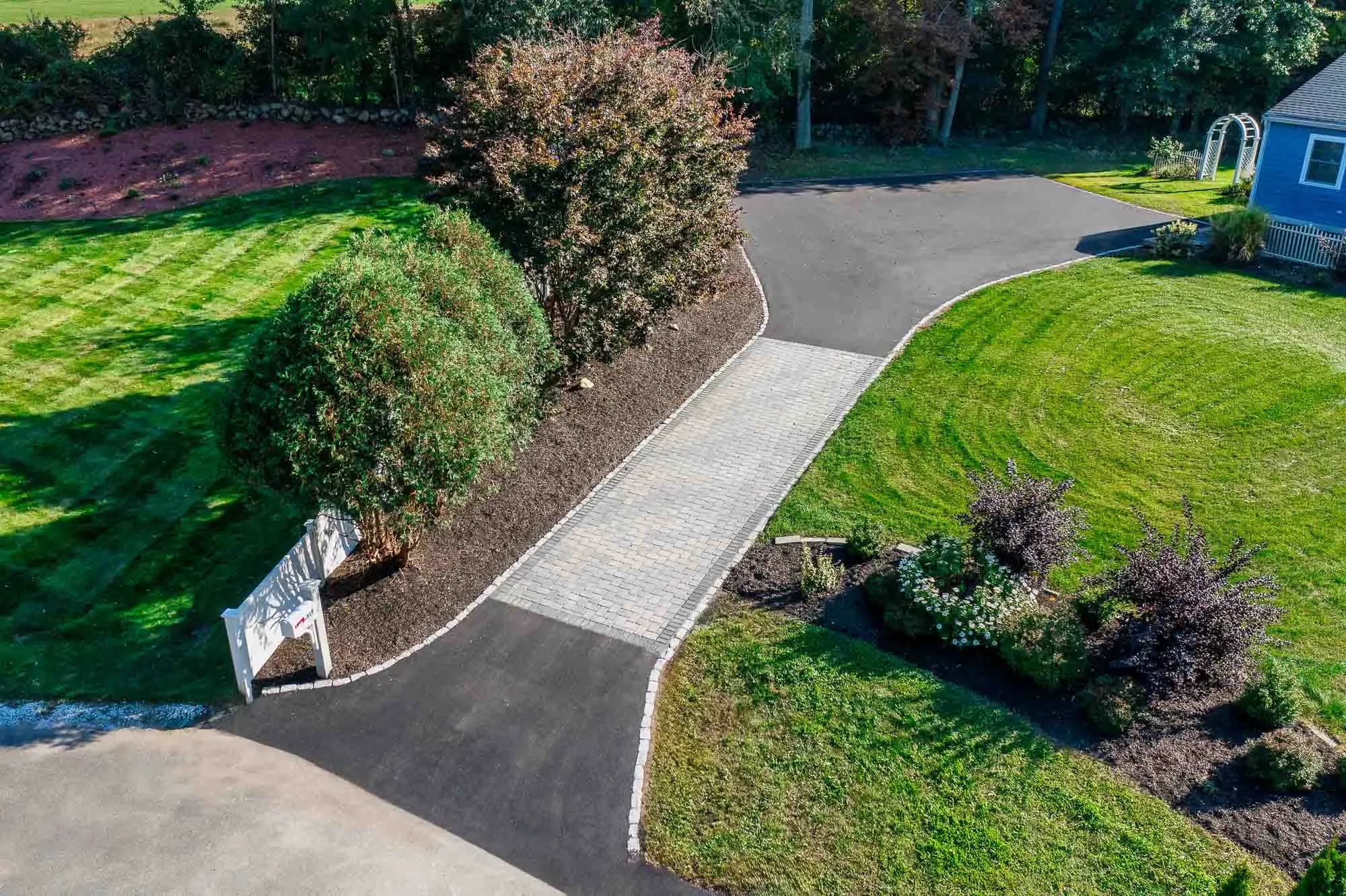 Crafting Durability and Elegance: Asphalt Meets Pavers for a Superior Driveway